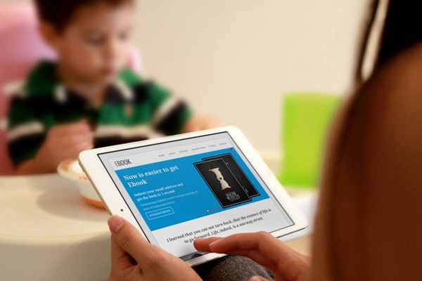 Business owner reviewing information on a tablet, preparing questions to ask an IT company before hiring