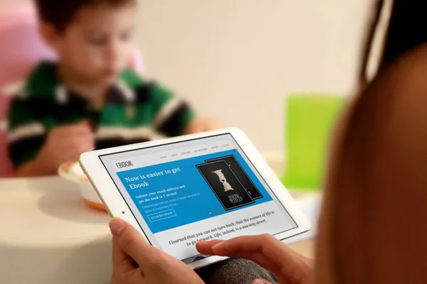 Business owner reviewing information on a tablet, preparing questions to ask an IT company before hiring